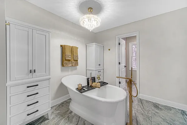 a spacious bathroom with double sink and a mirror