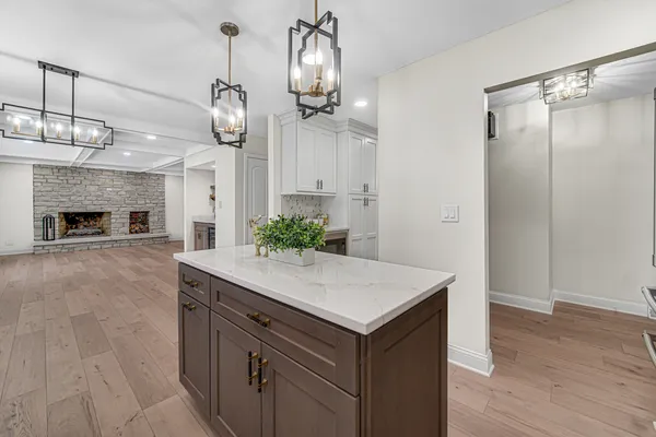 an empty room with wooden floor and fireplace