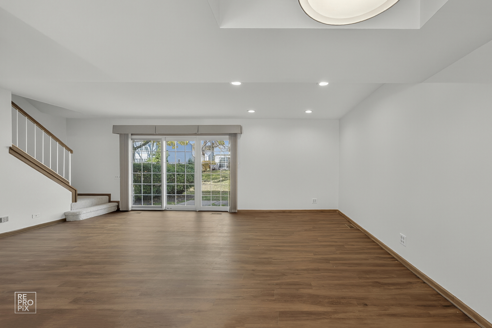 1884 Hastings Avenue Downers Grove, IL 60516 - Photo 2 of 10 a view of an empty room with wooden floor and a window