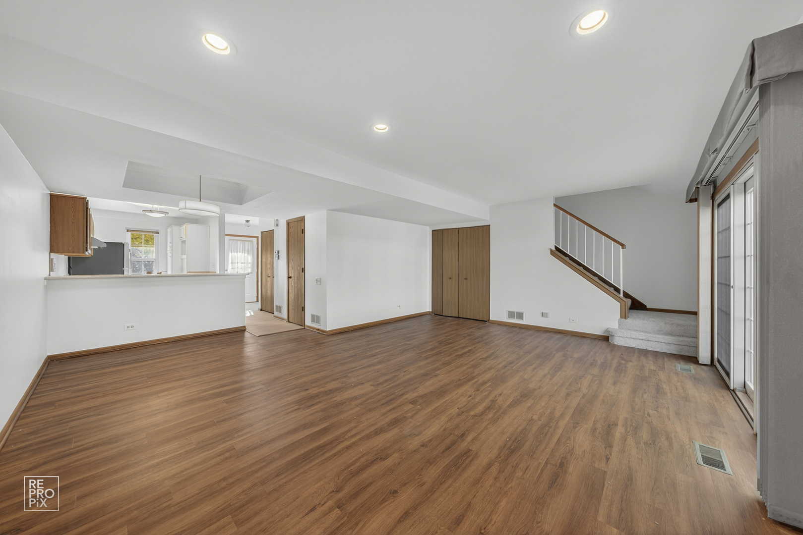 1884 Hastings Avenue Downers Grove, IL 60516 - Photo 3 of 10 a view of empty room with wooden floor and stairs