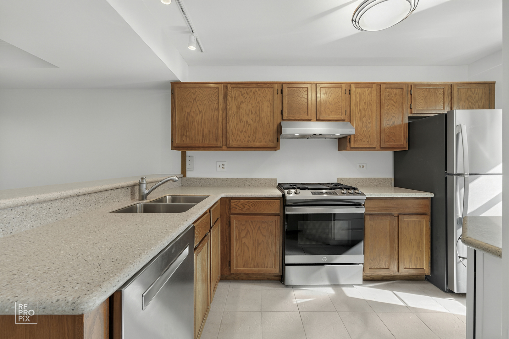1884 Hastings Avenue Downers Grove, IL 60516 - Photo 5 of 10 a kitchen with stainless steel appliances granite countertop a sink stove and refrigerator