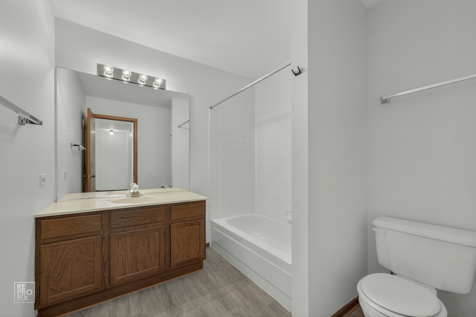 1884 Hastings Avenue Downers Grove, IL 60516 - Photo 9 of 10 a bathroom with a granite countertop sink toilet a large mirror a bathtub and shower