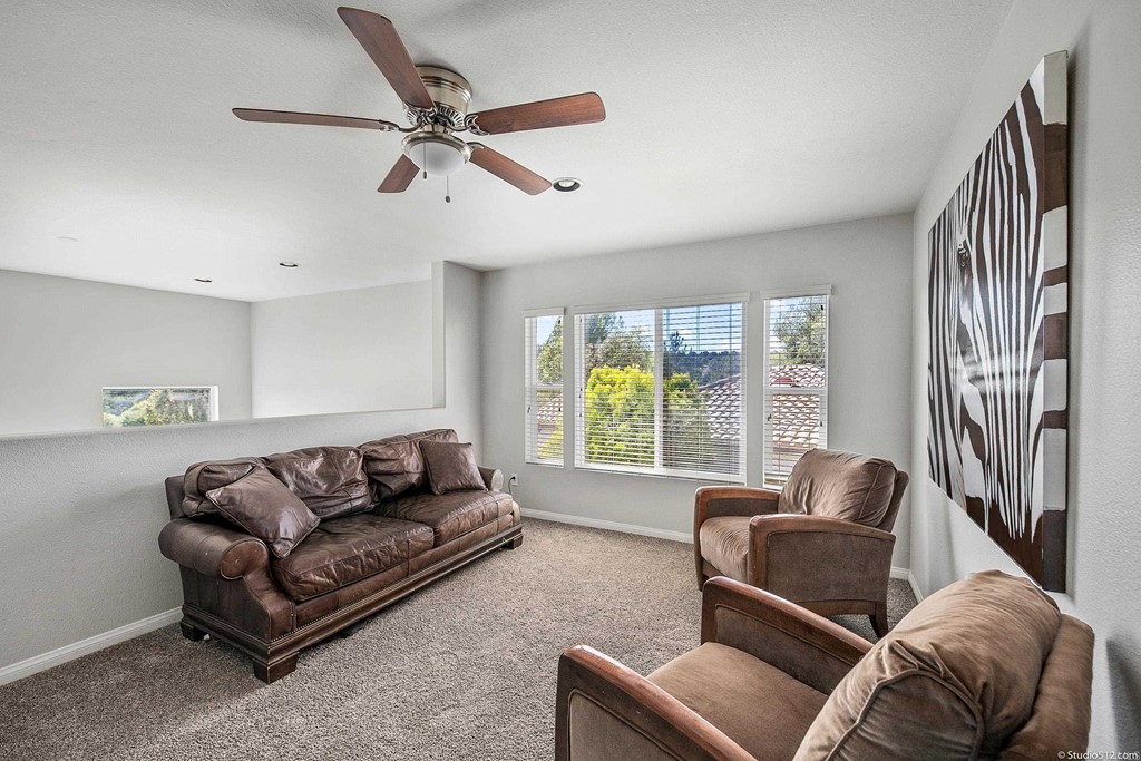 811 Inverlochy Drive Fallbrook, CA 92028 - Photo 12 of 27 a living room with furniture and a large window