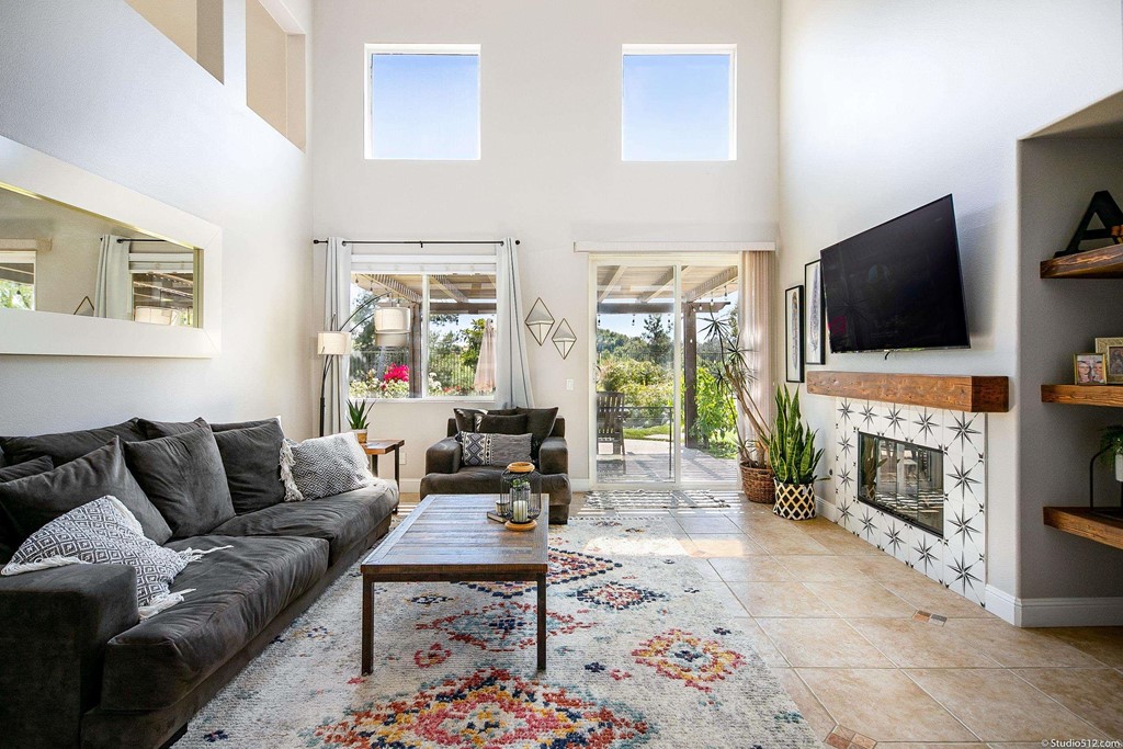 811 Inverlochy Drive Fallbrook, CA 92028 - Photo 10 of 27 a living room with furniture a fireplace and a flat screen tv