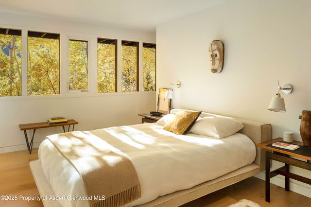 a bedroom with a bed and a table