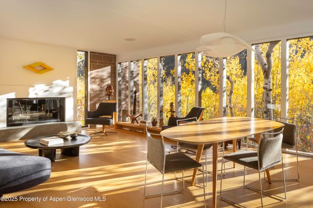 a very nice looking living room with a large window and a table