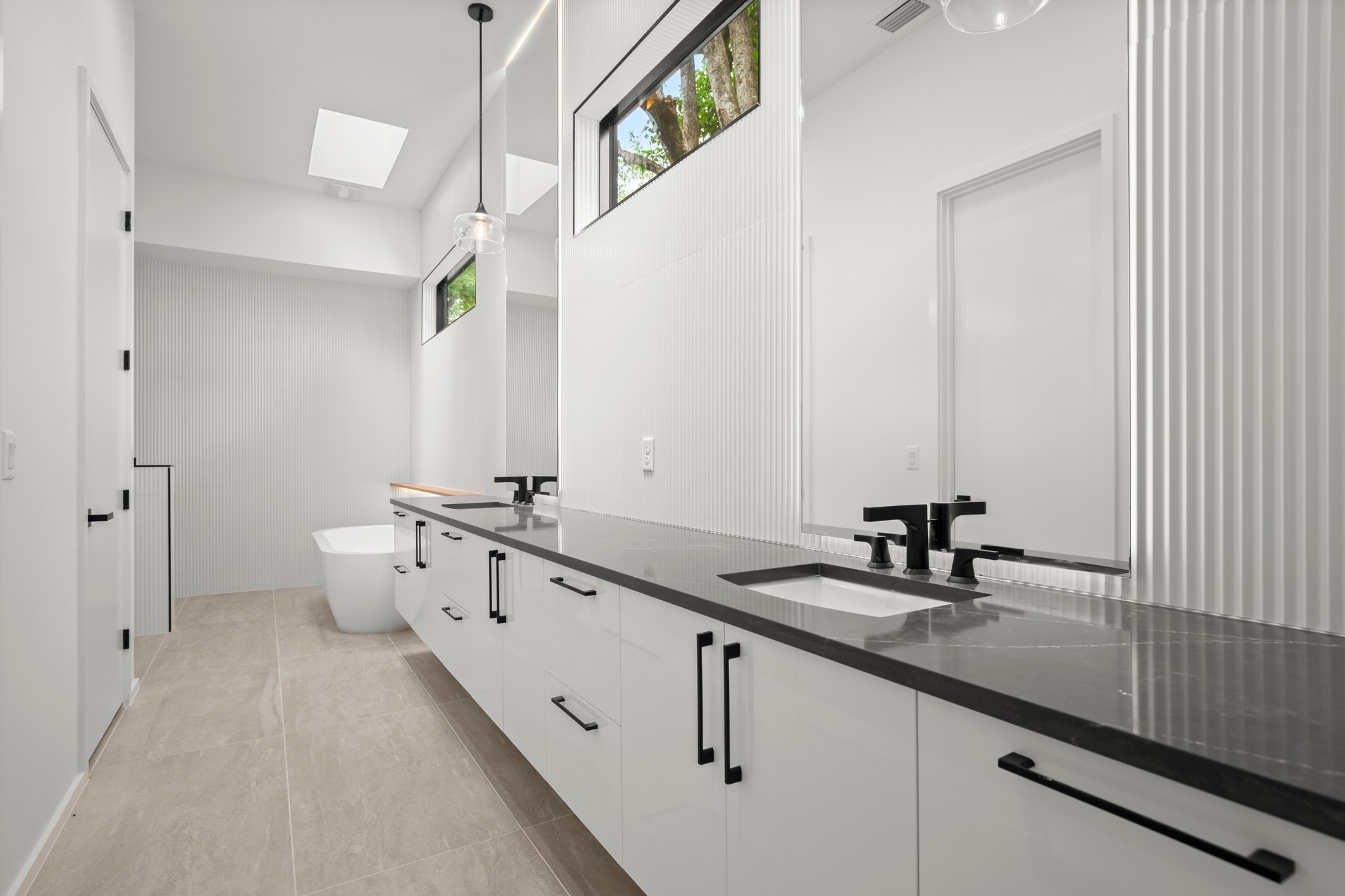 2215 South 3rd Street Austin, TX 78704 - Photo 20 of 38 a bathroom with a double vanity sink and mirror