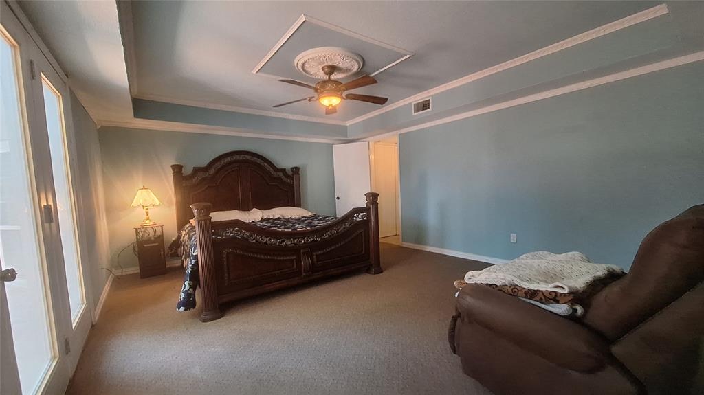 613 Colts Neck Court Colleyville, TX 76034 - Photo 11 of 38 first floor rear master with crtown mold accent tray ceiling, cdecorative fan, access entry hall from front living
