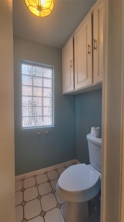 613 Colts Neck Court Colleyville, TX 76034 - Photo 15 of 38 separate toilet closet with upper cabinets & glass block window