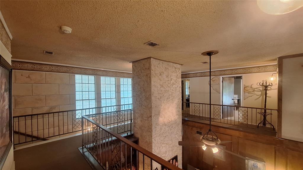 613 Colts Neck Court Colleyville, TX 76034 - Photo 28 of 38 upstairs loft stairwell area that views front entry upper windows with hallway to both split wings of 4 upstairs bedrooms or flex office & living space plus 2 full baths ensuite to 3 rooms