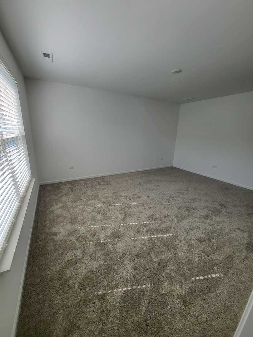 588 Wolverine Drive Aurora, IL 60502 - Photo 19 of 29 an empty room with windows
