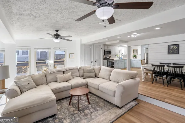 a view of a dining room with furniture and wooden floor
