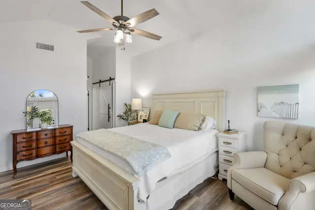 a spacious bathroom with a granite countertop sink a mirror and a window
