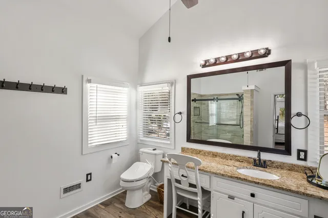 a bedroom with a bed a mirror and a window