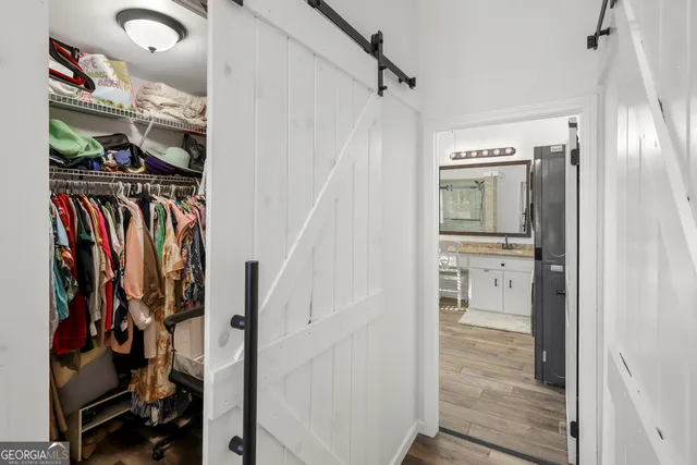 a bedroom with a bed a television and a large window