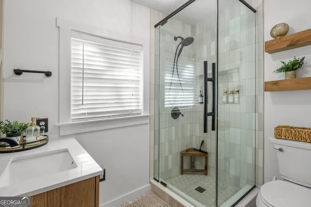 a view of a lake with boats and trees in the background