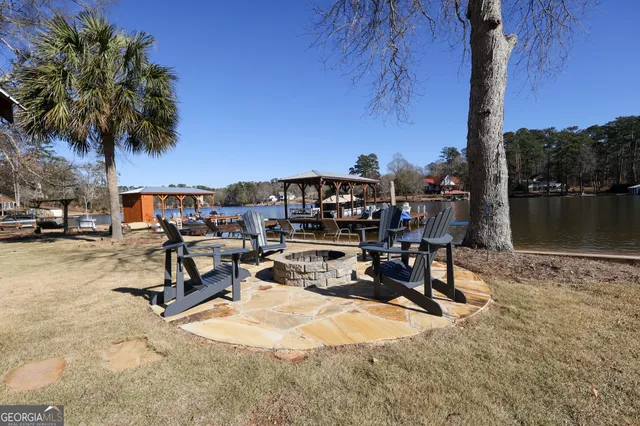 a dining room with lots of flower plants and wooden floor