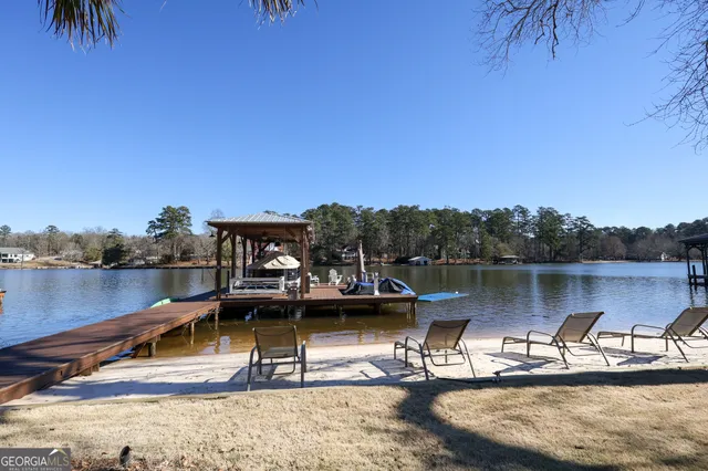 an aerial view of a house with a yard and lake view