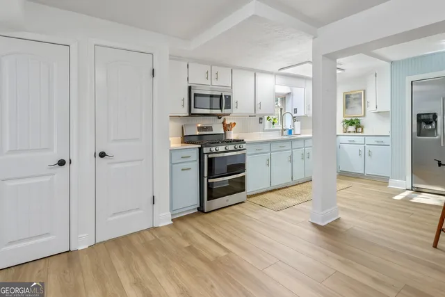 a kitchen with a refrigerator and a sink