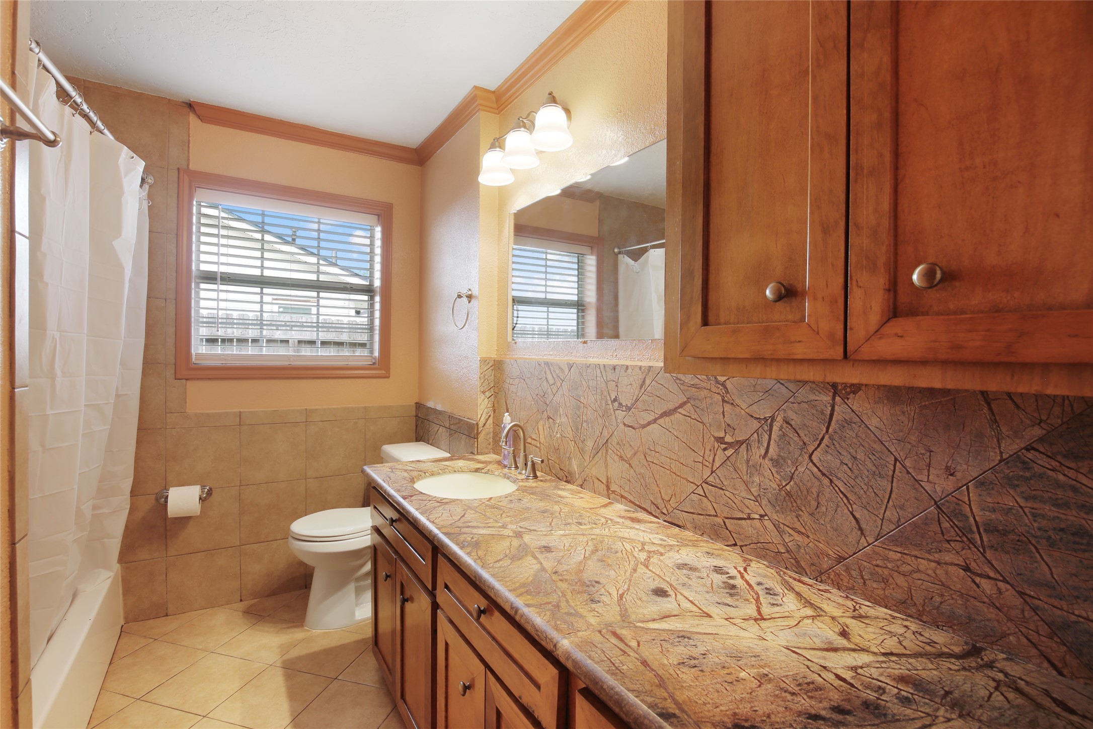 6923 Leader Street Houston, TX 77074 - Photo 6 of 19 a bathroom with a granite countertop sink and a mirror