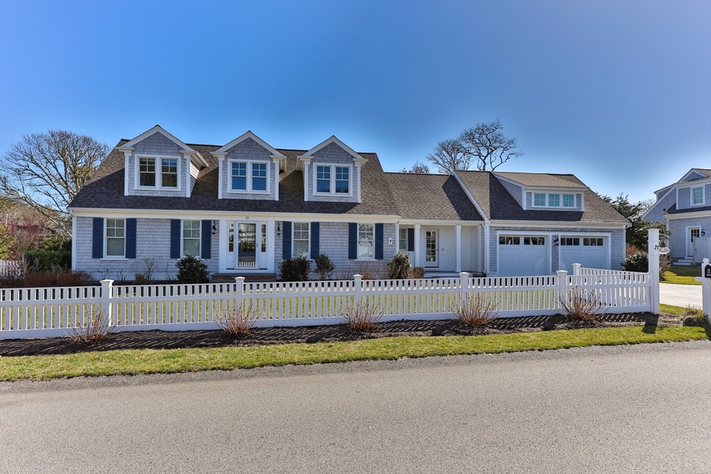 a front view of a house with a garden and yard