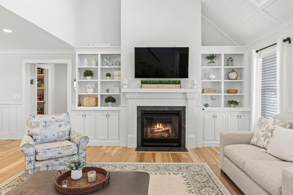 21 Hunter Rise Chatham, MA 02633 - Photo 6 of 37 a living room with furniture a flat screen tv and a fireplace