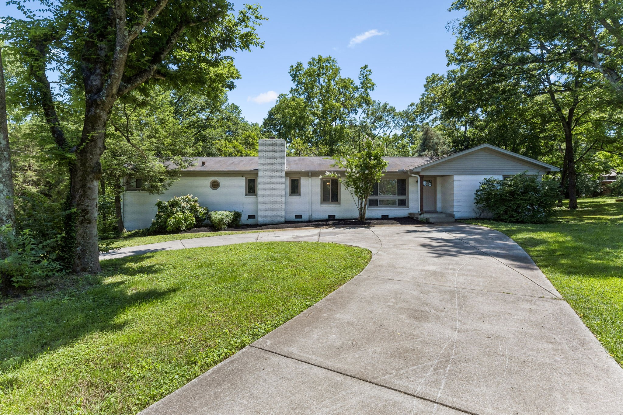 a front view of house with yard and green space