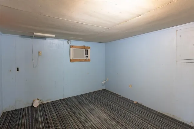 a view of a livingroom with wooden floor and a flat screen tv