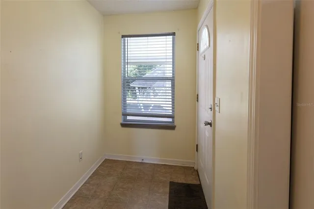 a view of a hallway to a bedroom and a kitchen