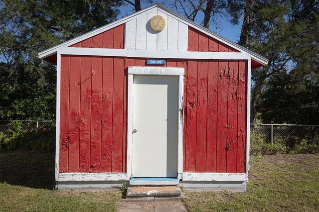 a view of a room with a bed and wooden floor