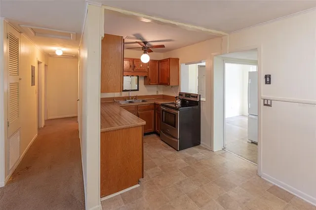 a kitchen with stainless steel appliances granite countertop a refrigerator stove and sink