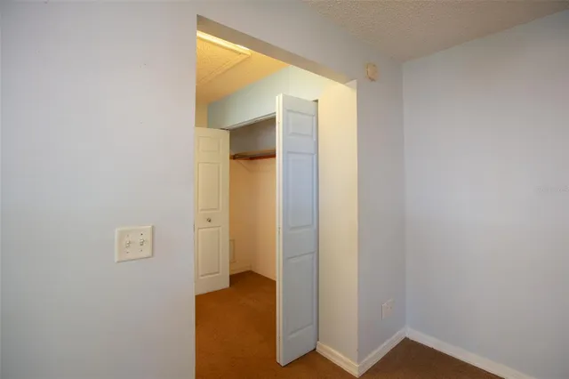 a view of an empty room and a window