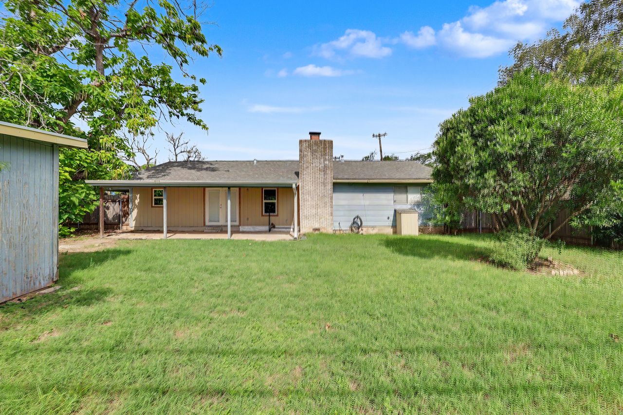 1811 Terry Lane Georgetown, TX 78628 - Photo 37 of 40 A spacious, verdant yard with ample room for outdoor activities, complemented by a covered patio area.