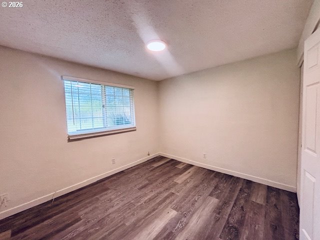 1940 Willow Street Florence, OR 97439 - Photo 13 of 18 an empty room with wooden floor and windows