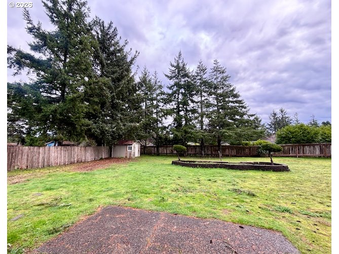 1940 Willow Street Florence, OR 97439 - Photo 16 of 18 a view of a backyard with a large tree