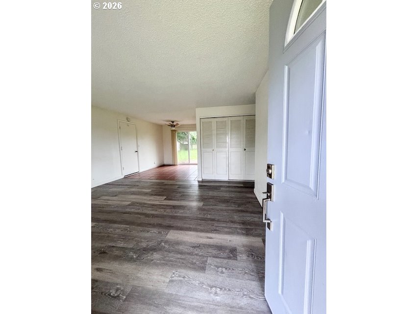 1940 Willow Street Florence, OR 97439 - Photo 2 of 18 a view of an empty room with wooden floor