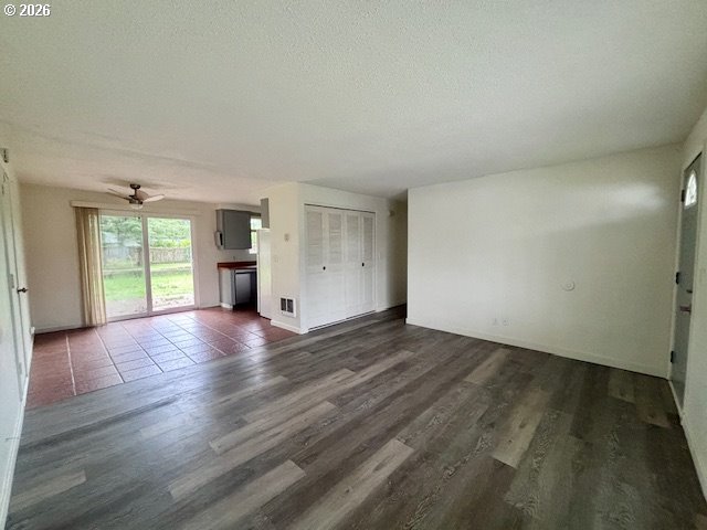 1940 Willow Street Florence, OR 97439 - Photo 3 of 18 an empty room with wooden floor and window