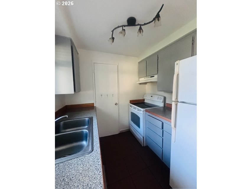 1940 Willow Street Florence, OR 97439 - Photo 5 of 18 a kitchen with a refrigerator and a sink