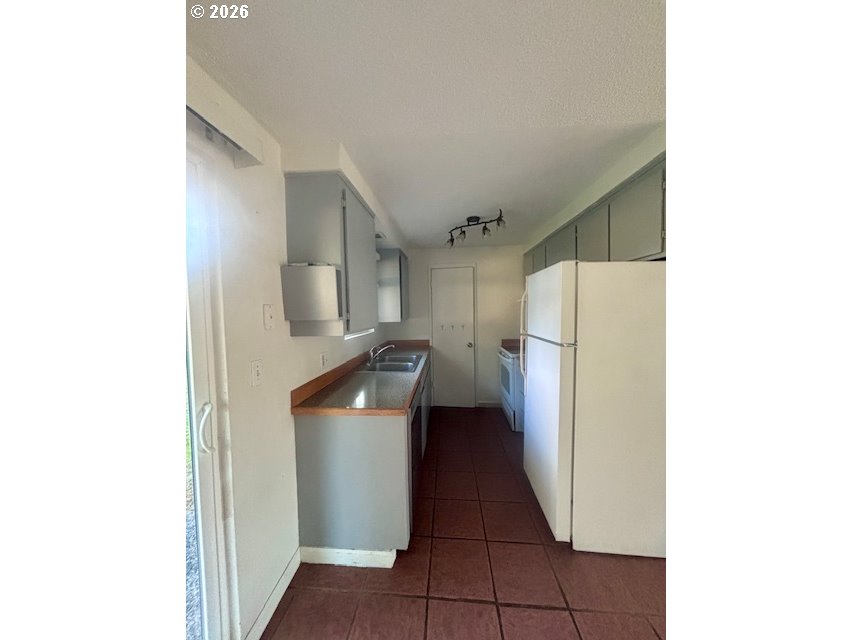 1940 Willow Street Florence, OR 97439 - Photo 6 of 18 a kitchen with a refrigerator and a sink