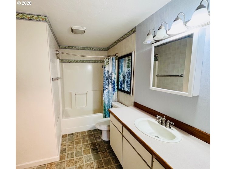 1940 Willow Street Florence, OR 97439 - Photo 7 of 18 a bathroom with a double vanity sink mirror and shower