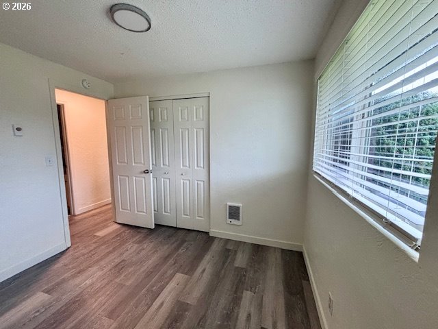 1940 Willow Street Florence, OR 97439 - Photo 10 of 18 a view of empty room with wooden floor and fan