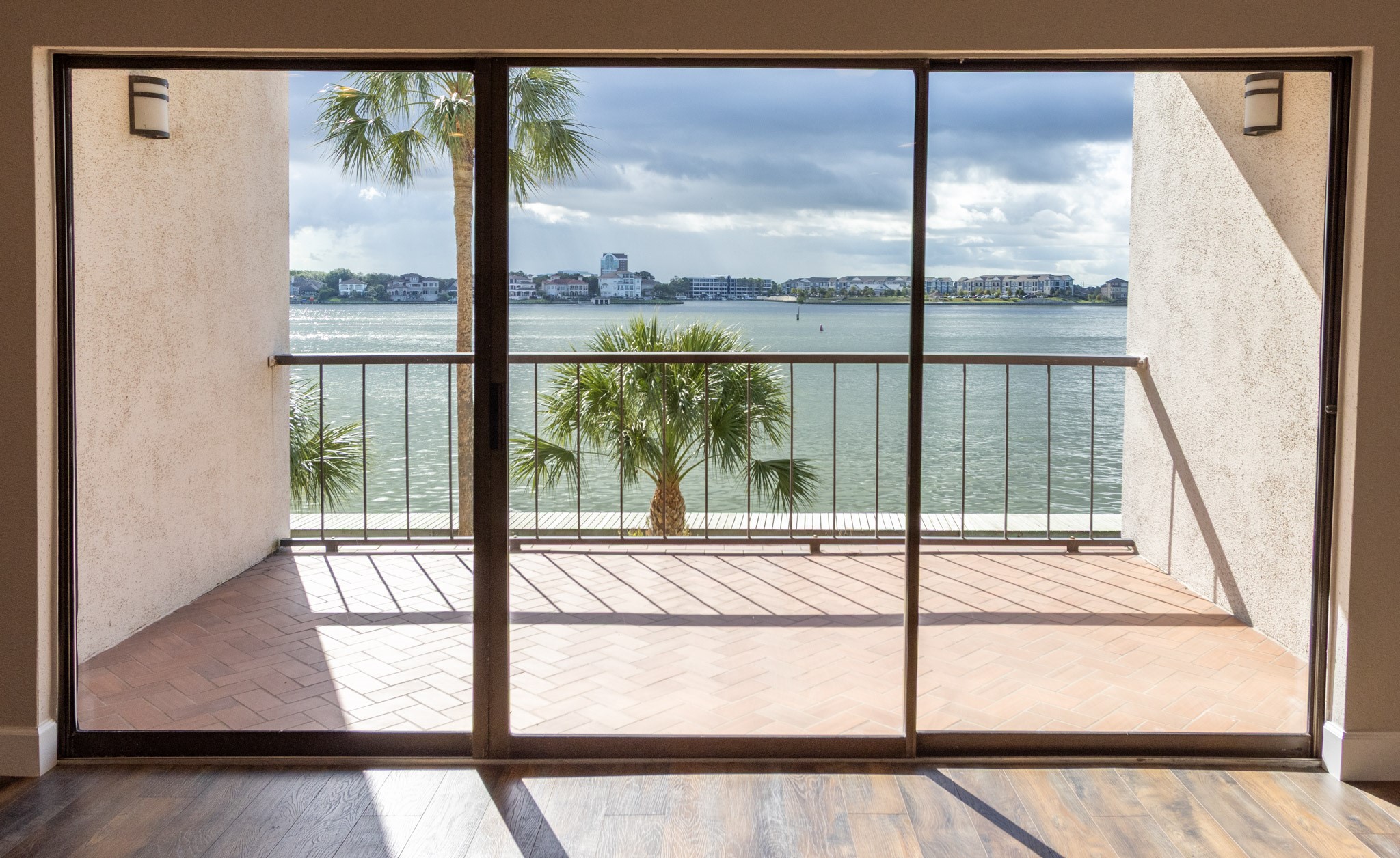 401 Lakeside Lane, Unit 111 Nassau Bay, TX 77058 - Photo 1 of 45 a view of a room with a large window and wooden floor