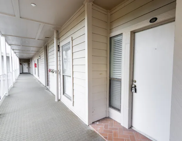 an aerial view of ocean and residential houses with outdoor space