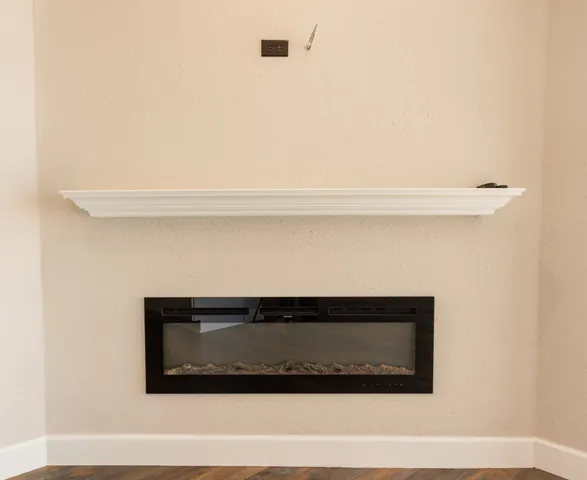 a kitchen with stainless steel appliances white cabinets and a stove a refrigerator with wooden floor