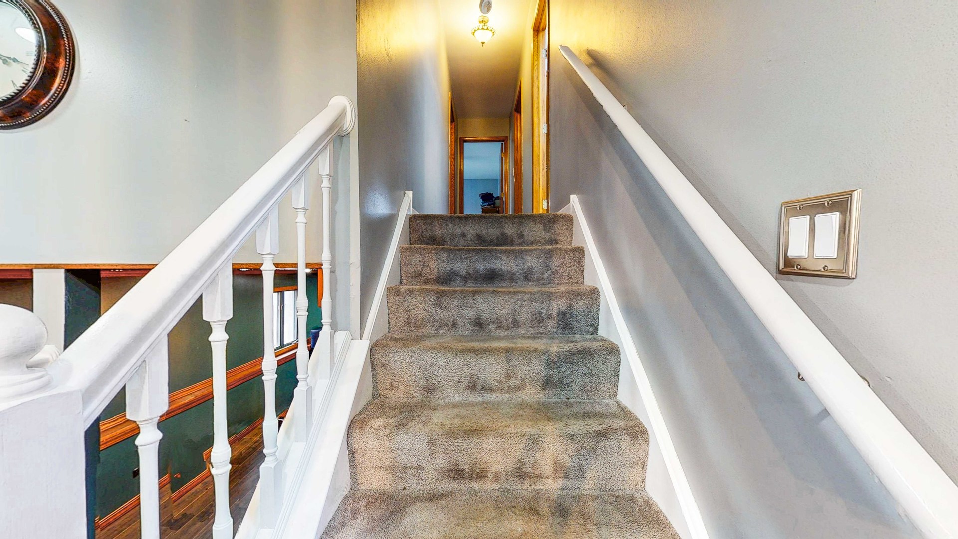 8129 45th Place Lyons, IL 60534 - Photo 24 of 45 a view of staircase with lots of frames on wall and a window