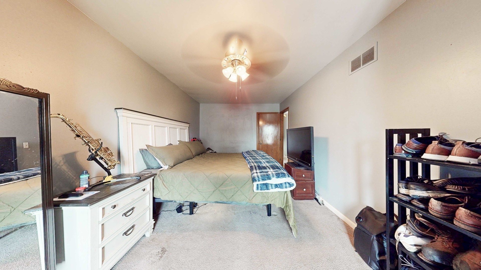8129 45th Place Lyons, IL 60534 - Photo 25 of 45 a spacious bedroom with a bed and a chandelier