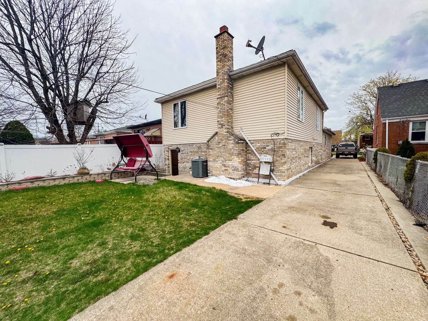 8129 45th Place Lyons, IL 60534 - Photo 3 of 45 a view of a backyard with table and chairs and a fire pit