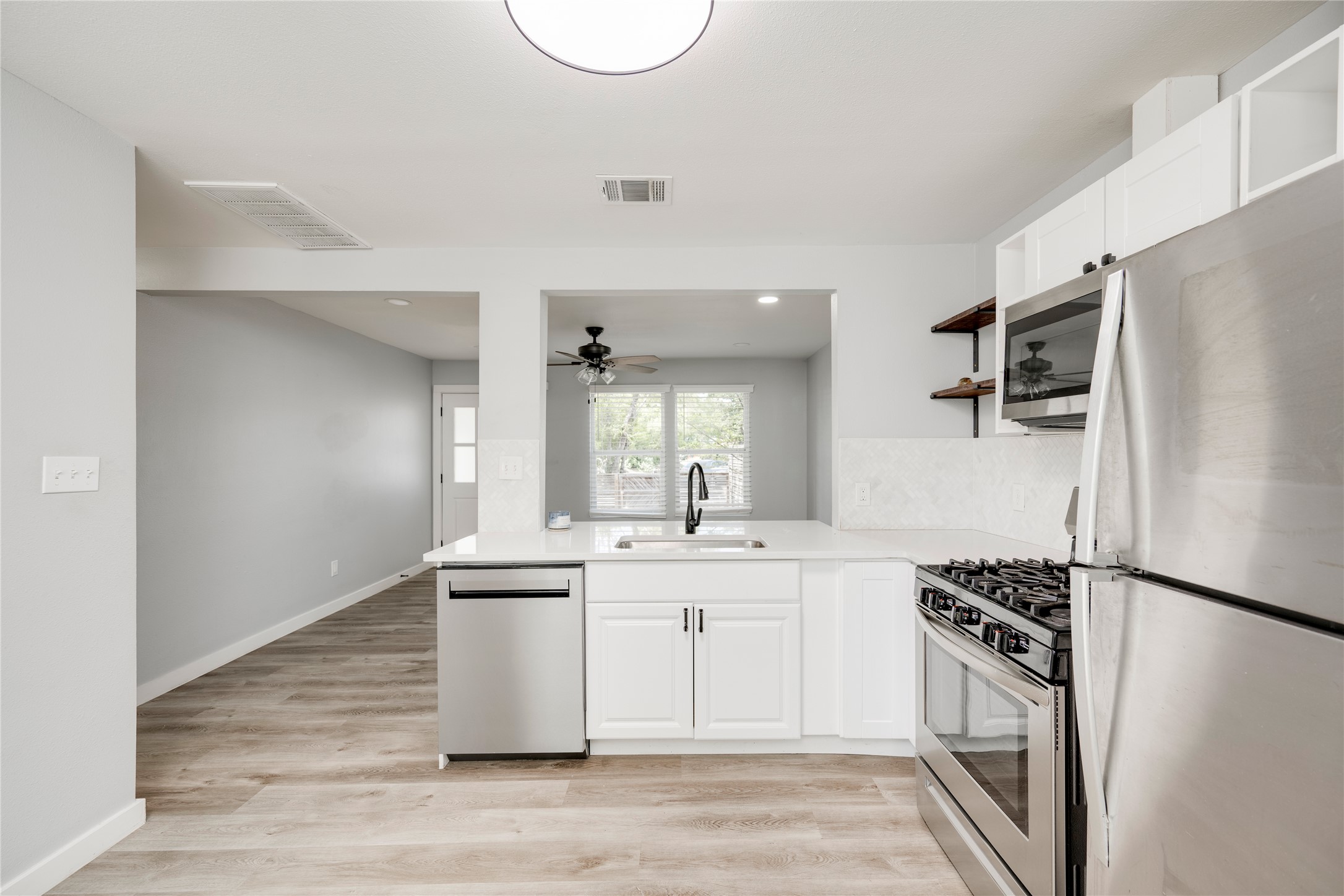 1400 Marcus Place, Unit B Austin, TX 78721 - Photo 25 of 39 A well-appointed kitchen boasts sleek countertops and modern stainless steel appliances.