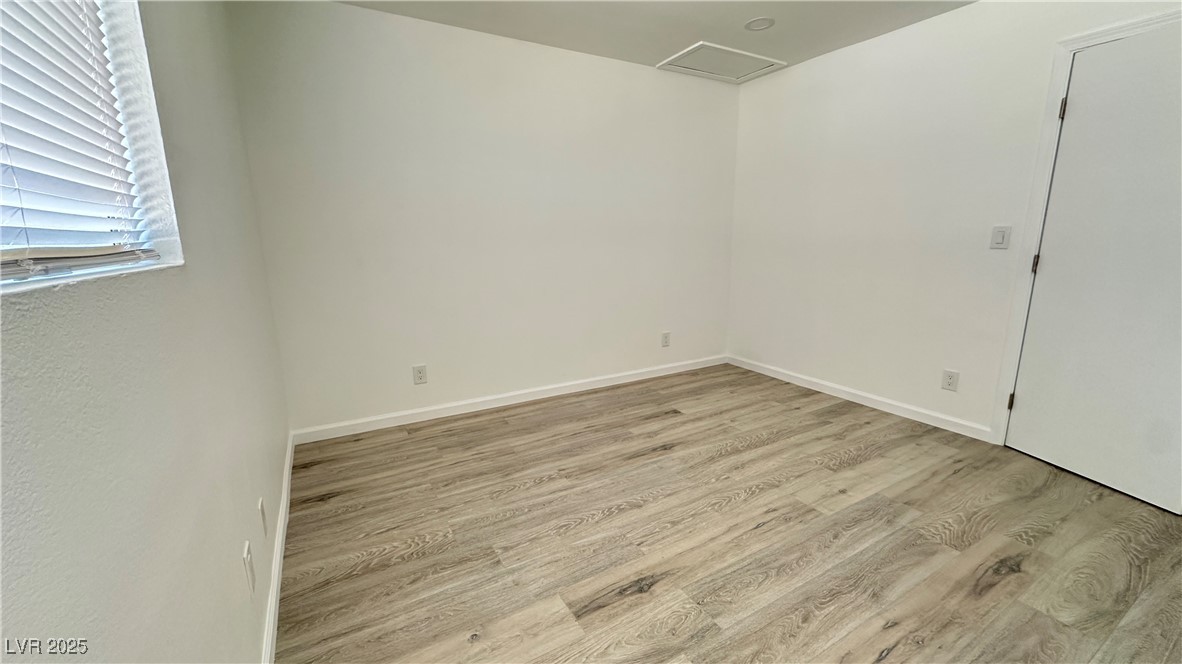 5108 Greene Lane, Unit D Las Vegas, NV 89119 - Photo 10 of 16 Spare room with light wood-type flooring and attic access