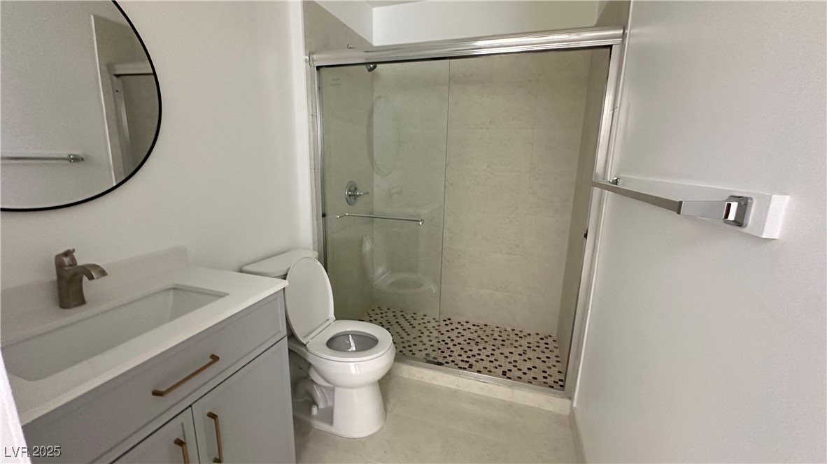 5108 Greene Lane, Unit D Las Vegas, NV 89119 - Photo 11 of 16 Full bath featuring a shower stall, vanity, and light tile patterned flooring